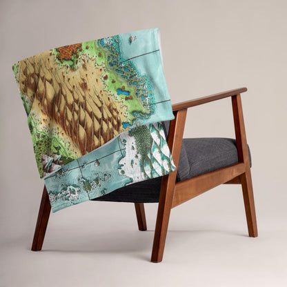 The Queen's Treasure map by Deven Rue is printed on a minky blanket, folded up on the back of a chair.