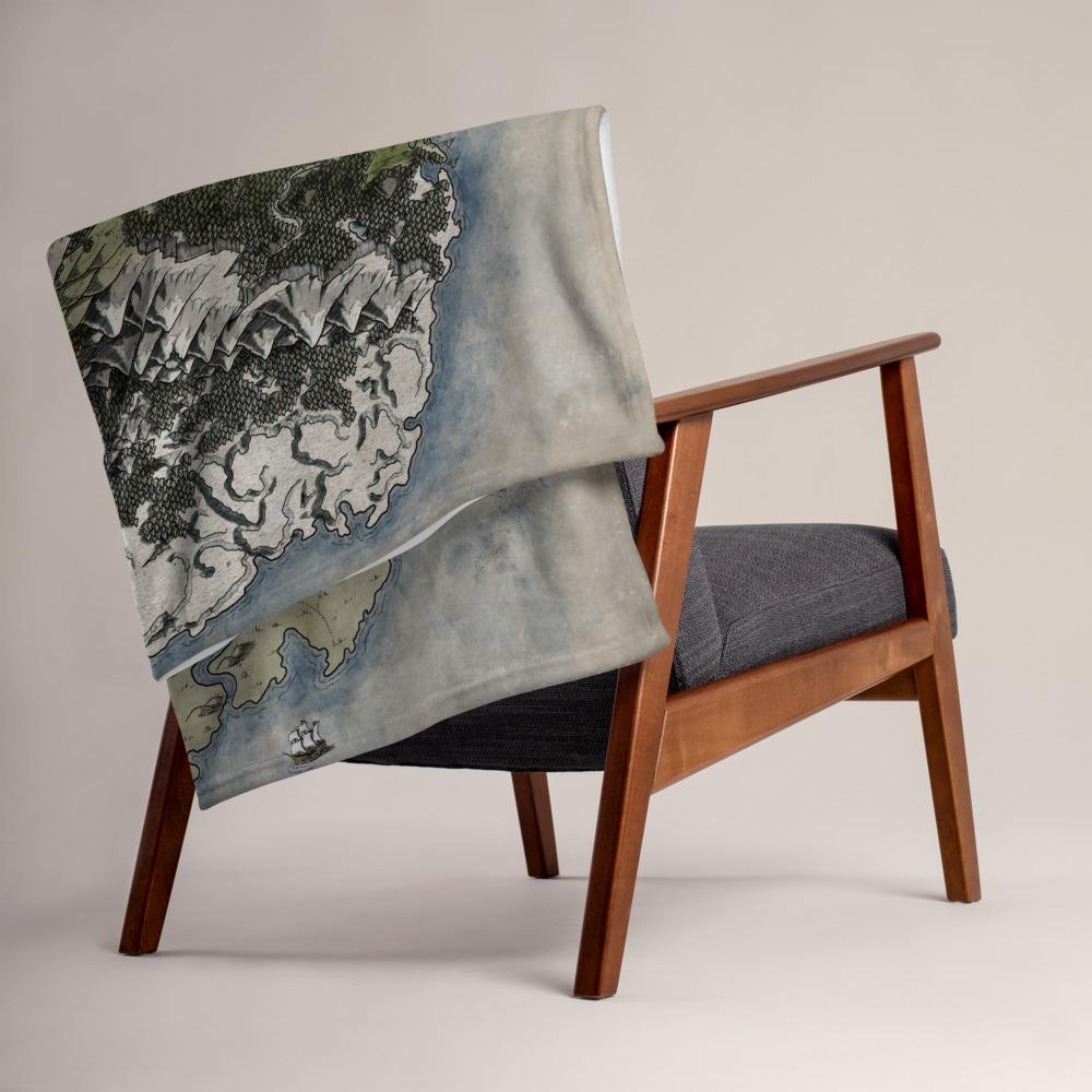The Vendras map by Deven Rue is printed on a minky blanket, folded up on the back of a chair.