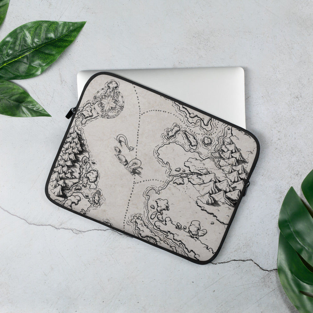 A laptop sleeve with a black and white map showing a sea monster between land masses. Greenery is around for scale.
