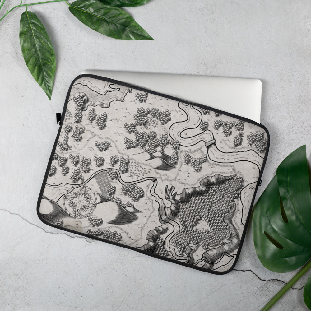 A laptop sleeve with a black and white map. Greenery is around for scale.