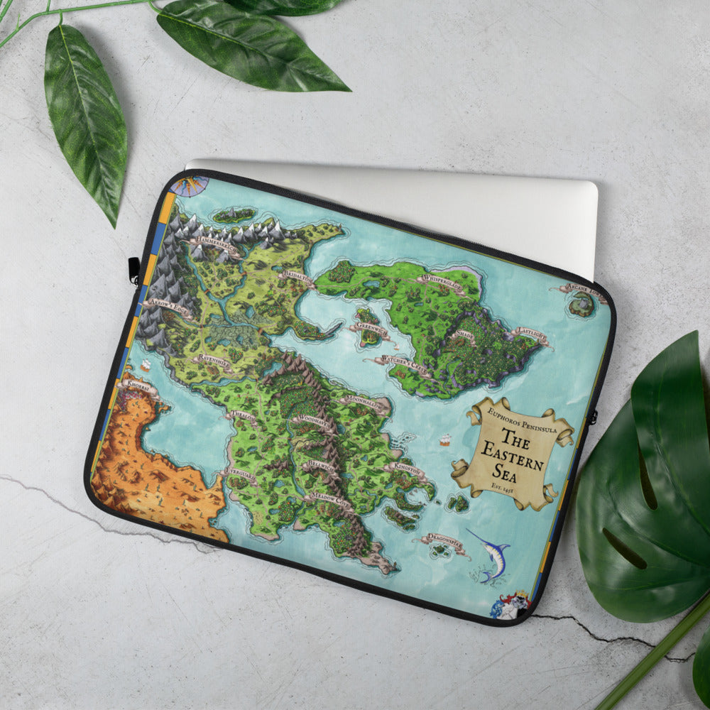 A laptop sleeve with the Euphoros Map by Deven Rue printed on it is set near leaves for scale.