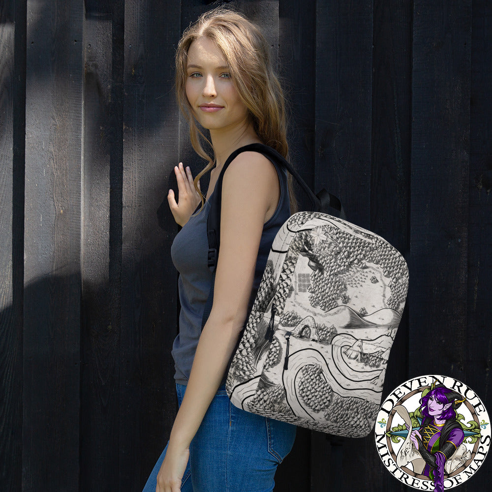 A model wears a backpack with the Magical Arch map by Deven Rue printed on it over one shoulder.