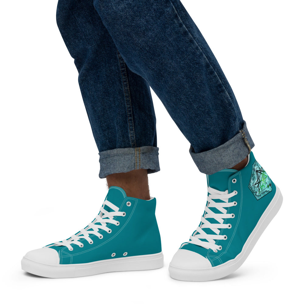 A model wears the teal high top shoes with the Discovering the Gate underwater hex map by Deven Rue on the heel with rolled up jeans.