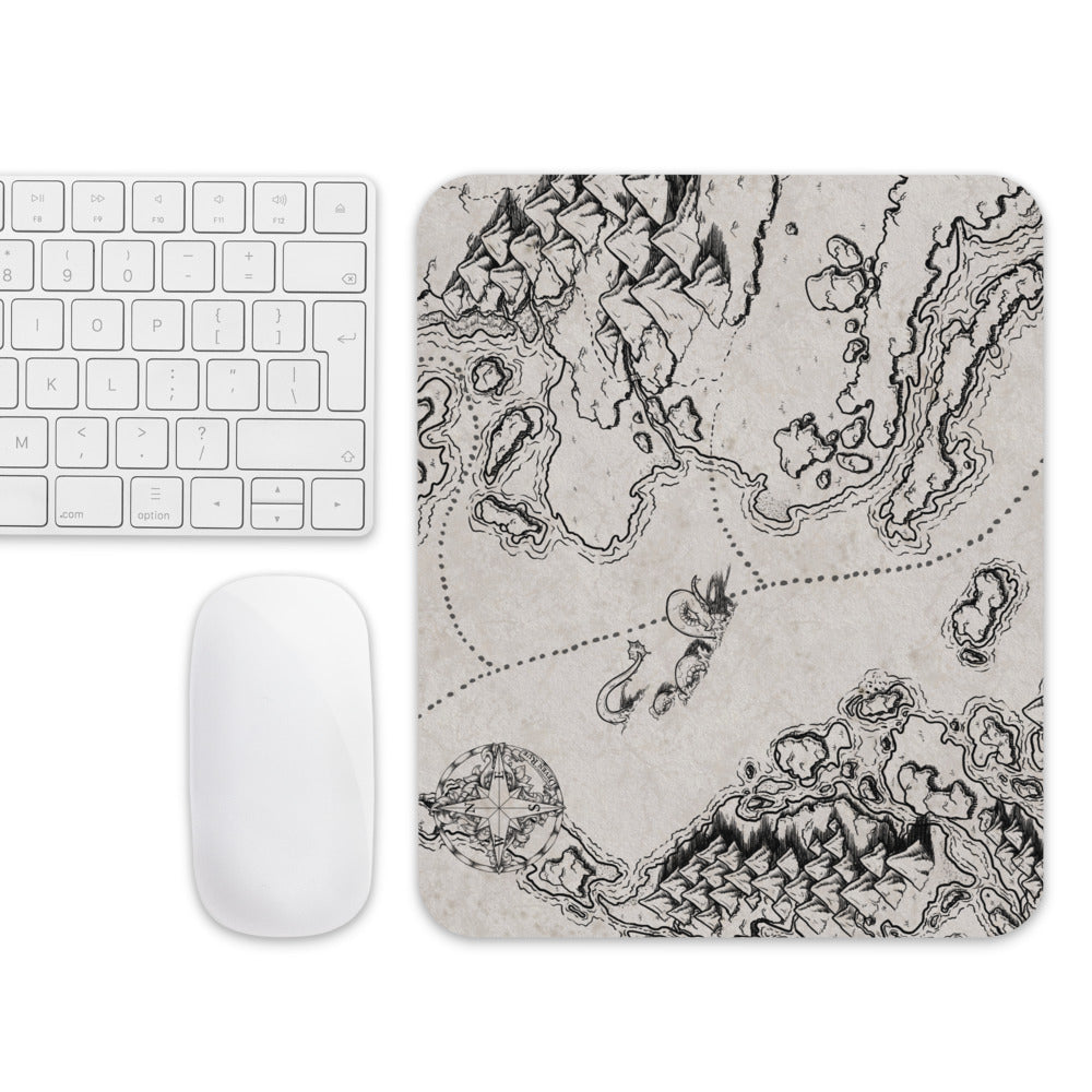 The There be Monsters mousepad with a mouse and keyboard for scale.