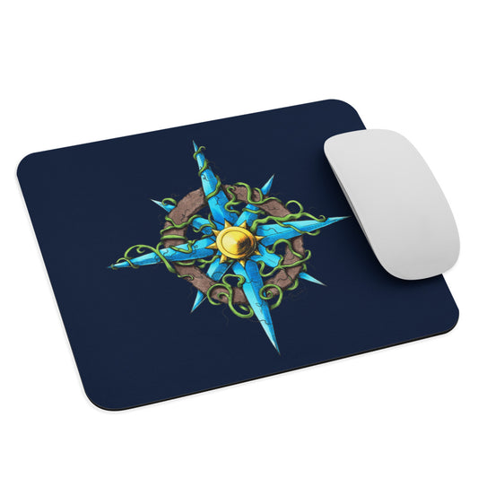 A dark blue mousepad with The Wilds Compass illustration and a mouse for scale.