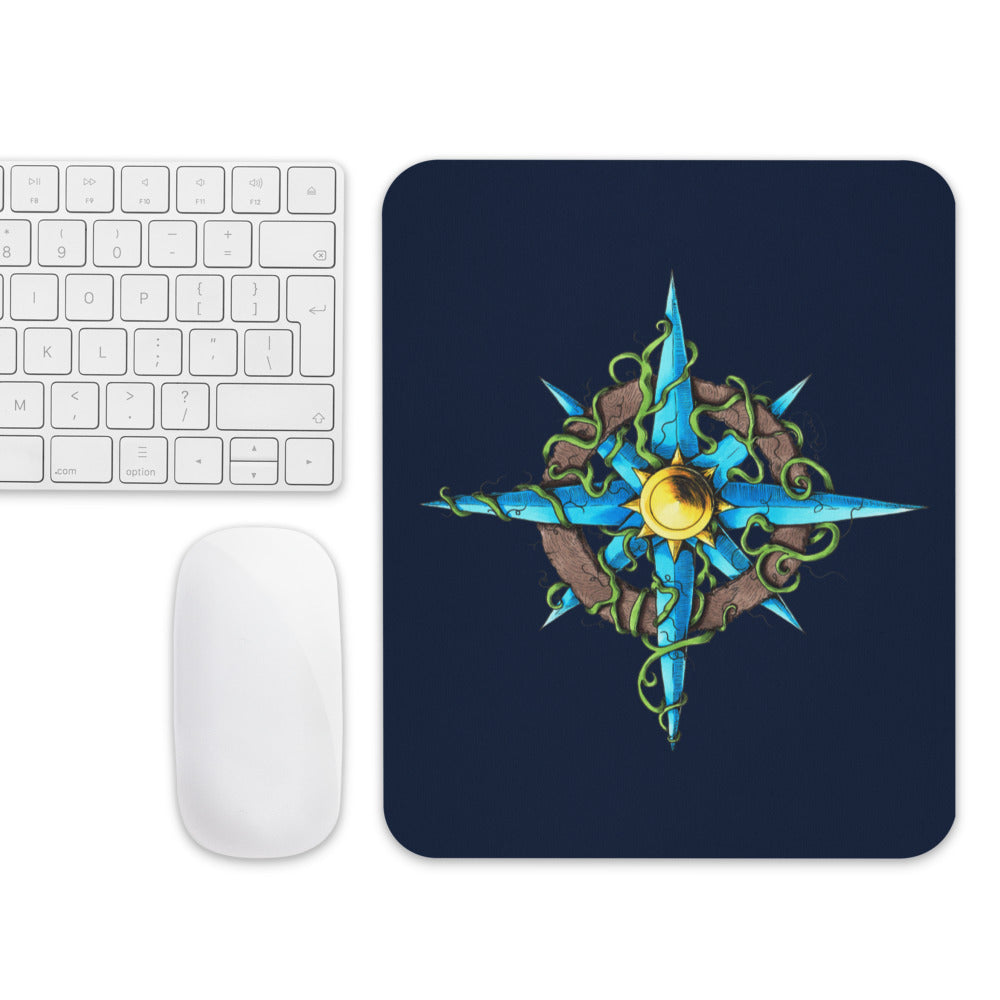 The Wilds Compass mousepad with a mouse and keyboard for scale.
