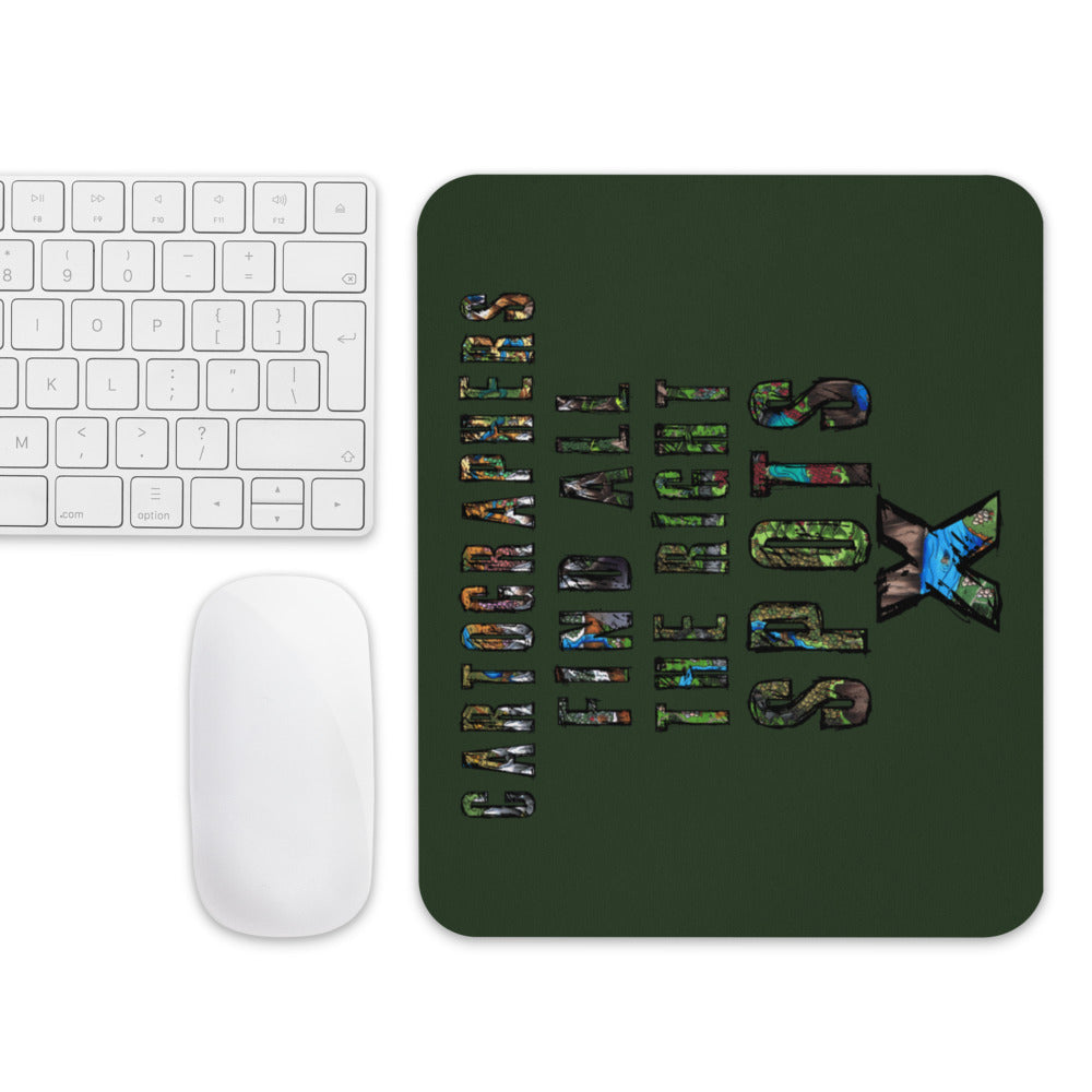 The "Cartographers find all the right spots" mousepad with a mouse and keyboard for scale.