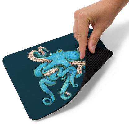 A hand picks up the corner of the Tangled Octopus mousepad.