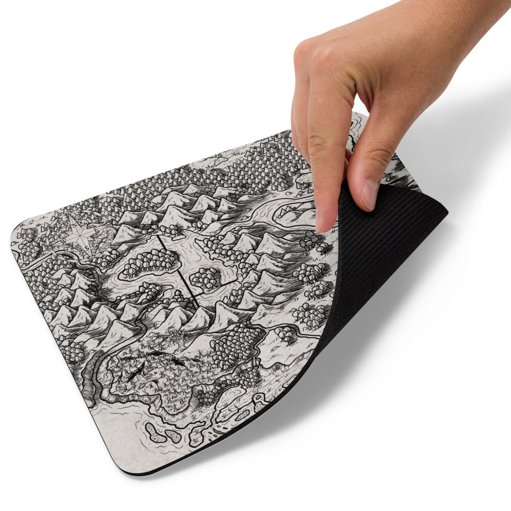 A hand lifts up the Unexpected mousepad.