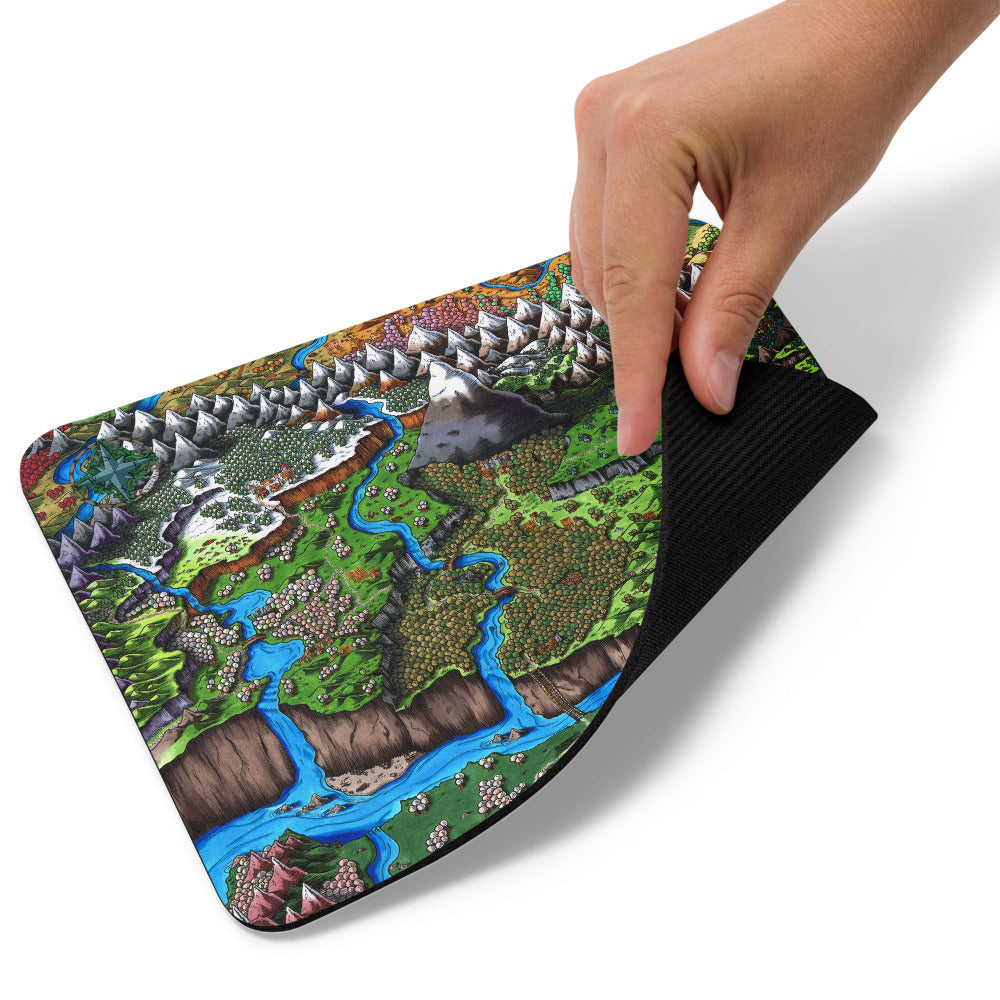 A hand pulls up the corner of the Augrudeen mousepad.