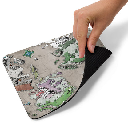 A hand pulls up the corner of the Ortheiad mousepad.