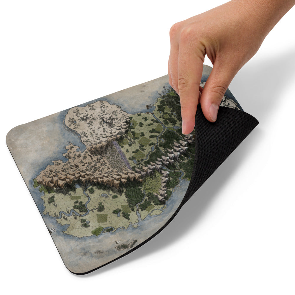 A hand lifts the corner of the Vendras mousepad.