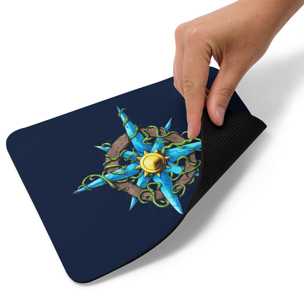 A hand picks up the corner of The Wilds mousepad.