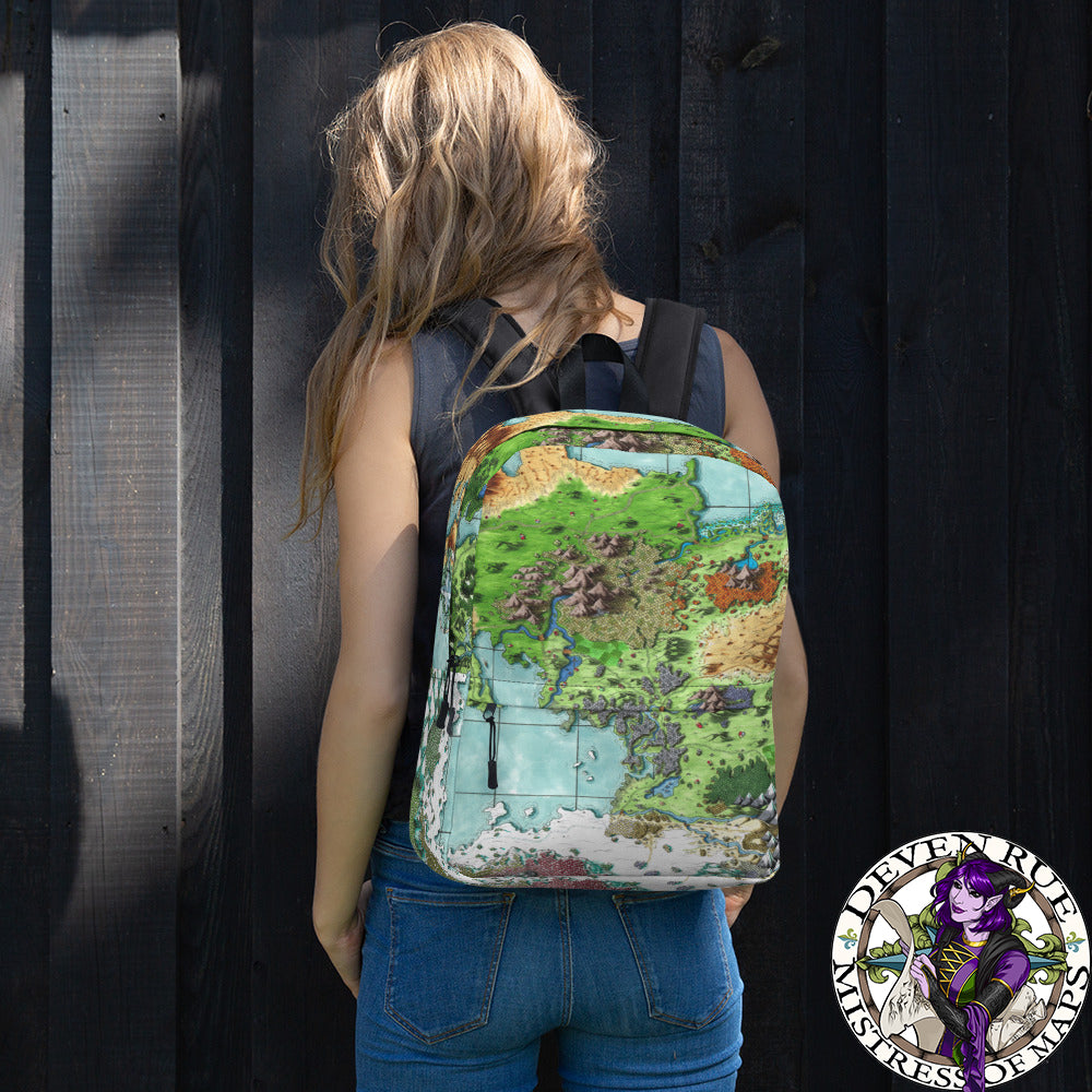 A model wears a backpack with The Queen's Treasure map by Deven Rue printed on it.