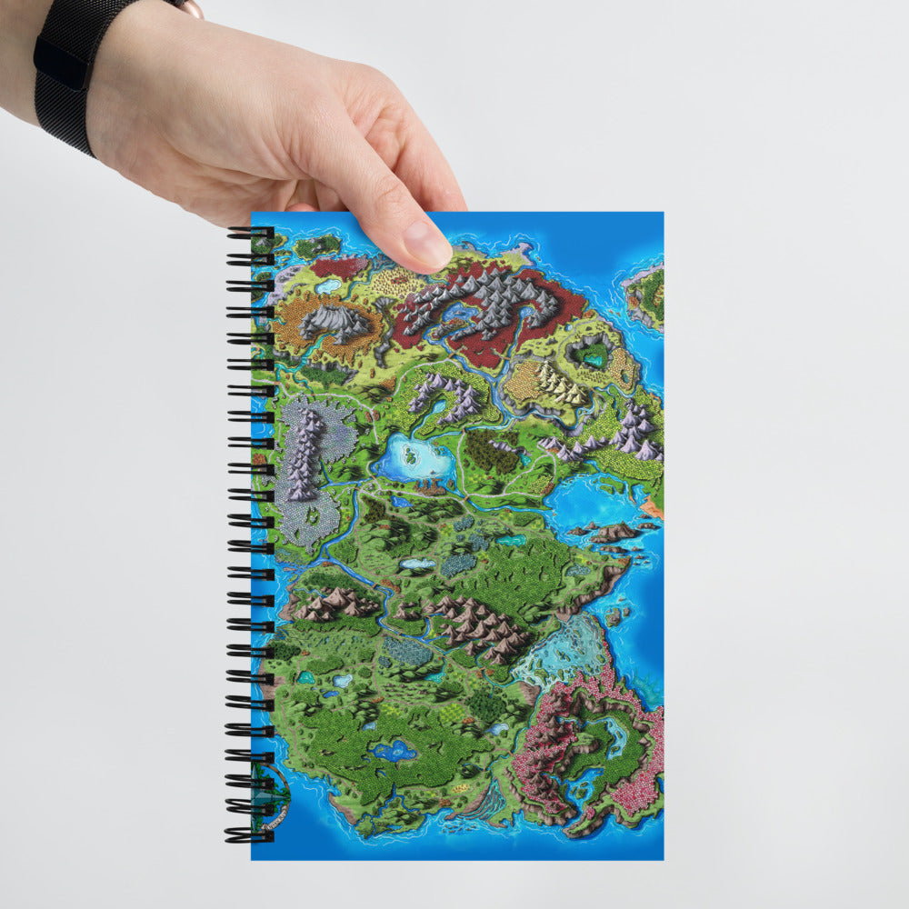 A hand holds a notebook with the Taur'Syldor map on the cover.