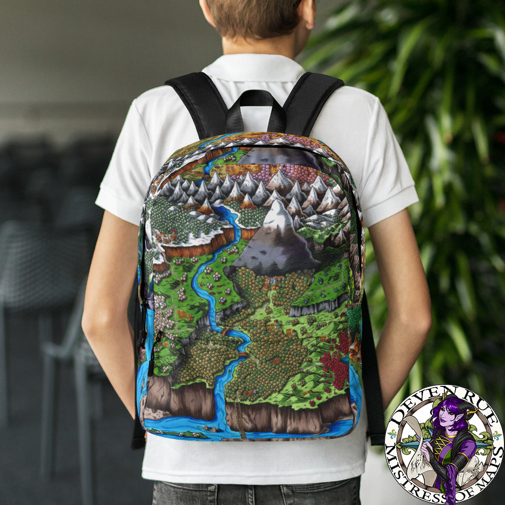 A model wears a backpack with The Steppes of Augrudeen map by Deven Rue printed on it.