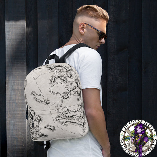 A model wears a backpack with the There Be Monsters map by Deven Rue printed on it.