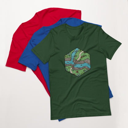 A green version of the Perilous Crossing shirt sits on top of the blue and red versions.