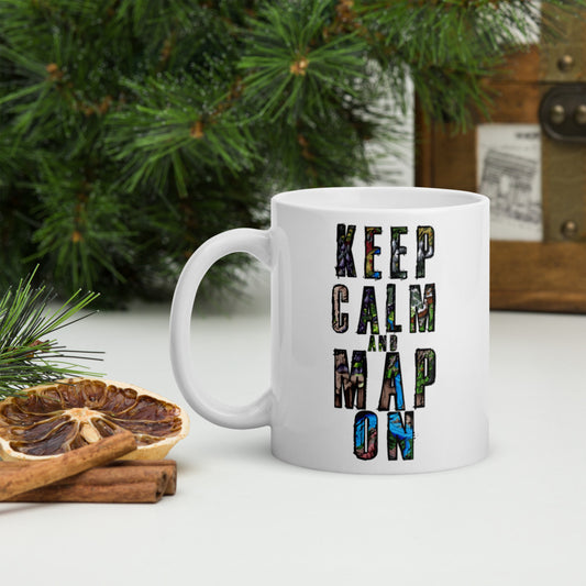 A mug reads "Keep Calm and Map On" overlayed in maps. The background includes cinnamon, desiccated orange, and pine for scale.