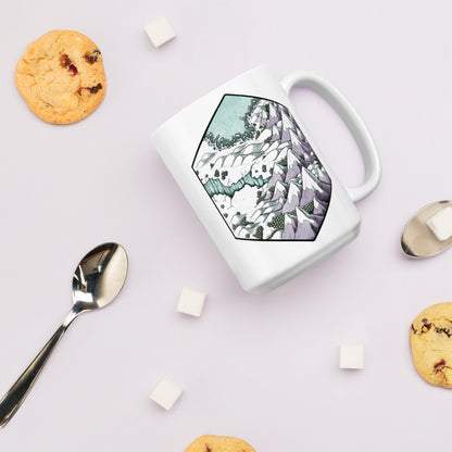 The previously described mug laid with some cookies, sugar cubes, and spoons for scale.